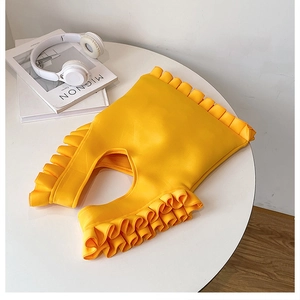 Close-up of bright yellow ruffled design on a stylish fashion item with soft pleats