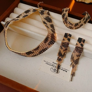 Macro shot of luxury leopard print jewelry set with rhinestones and tassel details