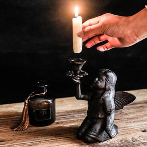 European vintage cast iron kneeling angel wing candle holder with dark textured finish