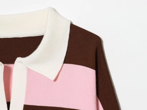 Detail of knit polo shirt collar showing fine stitching and pink white brown stripes