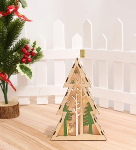 Close-up of laser-cut wooden Christmas tree ornament with warm LED lighting and reindeer
