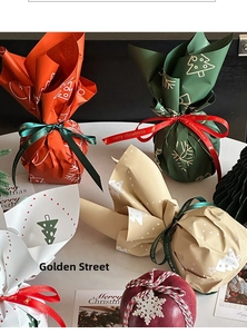 Detail of Christmas apple gift wrapping paper with Merry Christmas ribbons