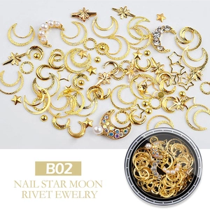 Detailed macro shot of B02 gold star moon nail charms with rivets and faux pearls