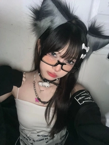 Detail shot of anime black half-frame glasses paired with cat ear headband and necklace