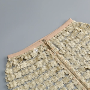 Macro detail of champagne gold lace pattern and high-quality metallic back zipper