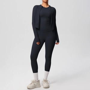 Three-piece black yoga set with zipper jacket and high-waisted leggings on model