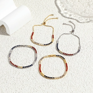 Retro multi-color zircon bracelets in gold and silver finish on white sand background