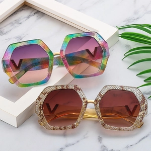 Stylish oversized hexagonal sunglasses with gradient lenses and V-shaped metallic detail