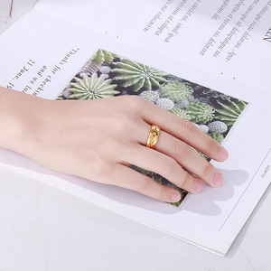 Elegant gold quilted texture ring in polished titanium steel worn on model hand
