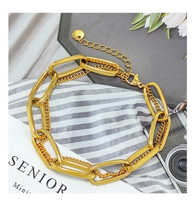 Close-up of golden titanium steel double-layer chunky chain bracelet with lobster clasp