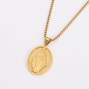 Detailed close-up of religious oval pendant and box chain in polished golden steel
