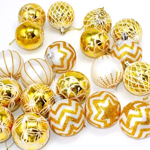Detail of 6cm gold and white Christmas balls with glitter patterns and geometric textures
