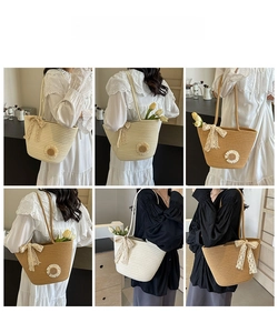 Detailed view of woven straw tote bag featuring delicate lace bows and sunflower accents