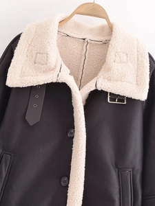 Close-up of faux leather and shearling biker jacket with collar buckle details