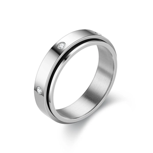 Detail of brushed titanium steel ring with black stripes and inset cubic zirconia