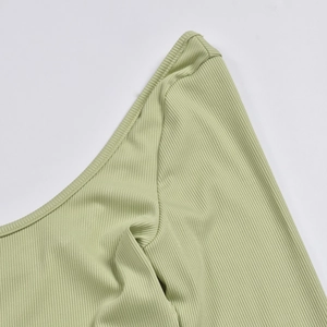 Detail of light green ribbed knit fabric showing the shoulder and U-neckline texture