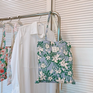 Floral print cotton canvas tote bags in French oil painting style on display rack