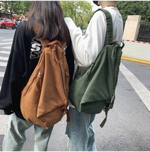 Street view of casual canvas backpacks in brown and dark green for daily lifestyle