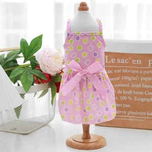 Detailed view of pink pet dress featuring colorful polka dots and a large satin bow