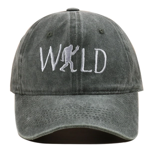 Detailed close-up of WILD embroidery and bigfoot silhouette on washed dark gray baseball cap