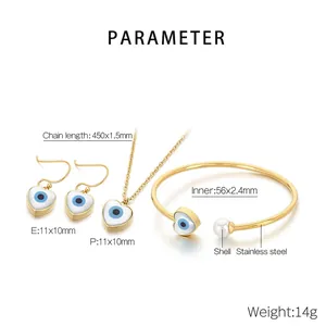 Detail of gold stainless steel jewelry set with evil eye shell pendants and white pearl