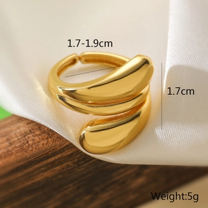 Detailed view of irregular gold wrap ring dimensions on silk and wood background