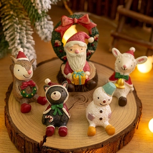 Miniature resin Christmas figurine set with Santa and reindeer on wooden display stand