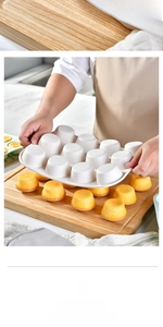 White 12-cup silicone muffin pan showing easy release with baked cupcakes on a board