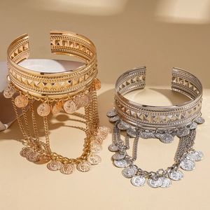 Bohemian gold and silver metal open bracelets with coin pendants and tassel details