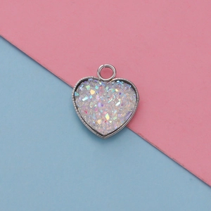 Macro detail of 13mm heart-shaped stainless steel pendant with glitter resin filling
