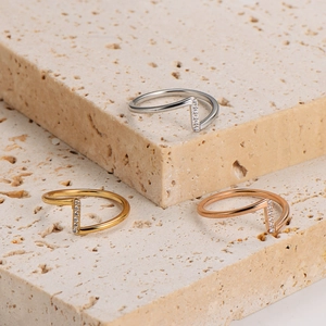 Three-piece set of wave shaped stainless steel rings with crystals in gold and silver