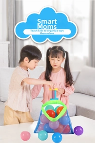 Kids using blue mesh toy storage bag with colorful balls in a home living room setting