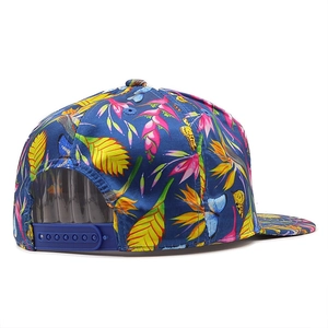 Flat brim baseball cap with tropical floral print and adjustable snapback closure