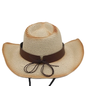 Close-up of beige straw sun hat with brown gradient brim and leather band detailing