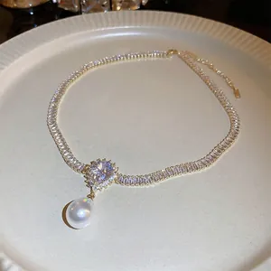 Gold plated necklace featuring rectangle zircons and a pear-shaped pearl drop pendant