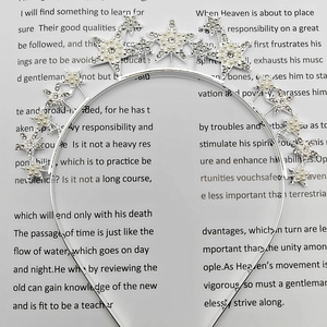 Detail of silver star headband with sparkling rhinestones and elegant pearls