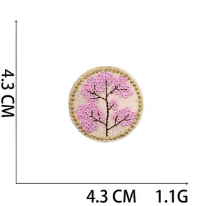 Close-up of a 4.3cm round cherry blossom patch with gold wire embroidery and 1.1g weight
