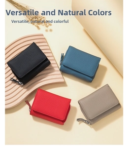 Macro shot of trifold leather wallets in four colors with pebble grain texture details