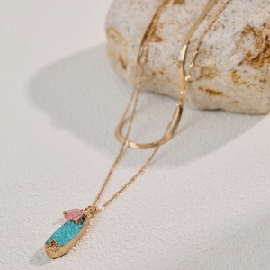 Double-layered gold snake chain necklace with green and pink crystal teardrop pendant