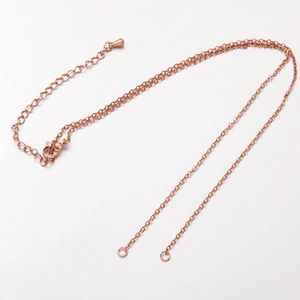 Macro detail of rose gold stainless steel DIY jewelry chain with lobster clasp and links