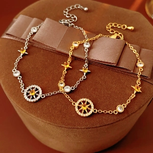 French star and compass charm bracelet with zircon in gold and silver finish