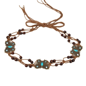 Bohemian braided belt with metallic butterflies and wood beads on white background