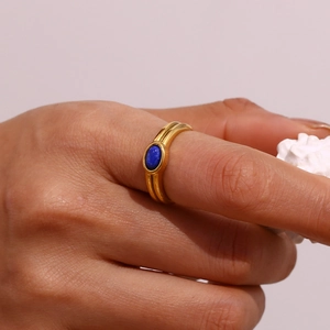 Detail of 18K gold-plated ring with oval blue stone on a split shank band