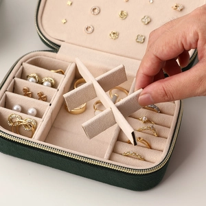 Portable dark green velvet jewelry box with adjustable storage compartments for rings