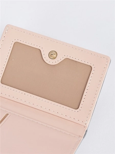 Detail of pink wallet showing card slots, neat stitching and golden snap button