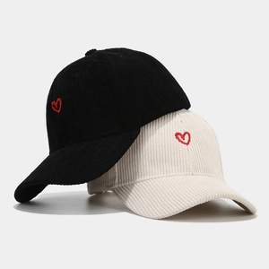 Minimalist corduroy baseball cap with red heart embroidery in black and off-white colors