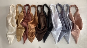 Flat lay display of multi-color satin hair scarves with elastic bands and silk texture