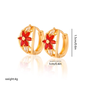 Detail view of 18K gold hoop earrings with red crystal flower design and size markers