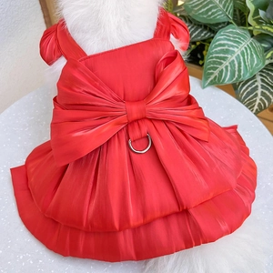 Detail of red satin pet dress with large bow and metal D-ring for leash attachment