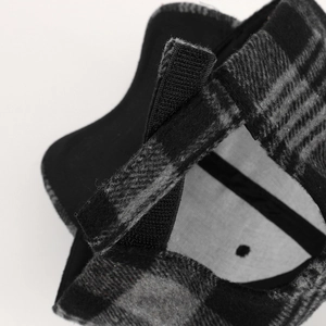 Detail view of the black and gray plaid baseball cap showing adjustable velcro strap